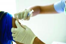 A health care provider administers a flu vaccine to a patient